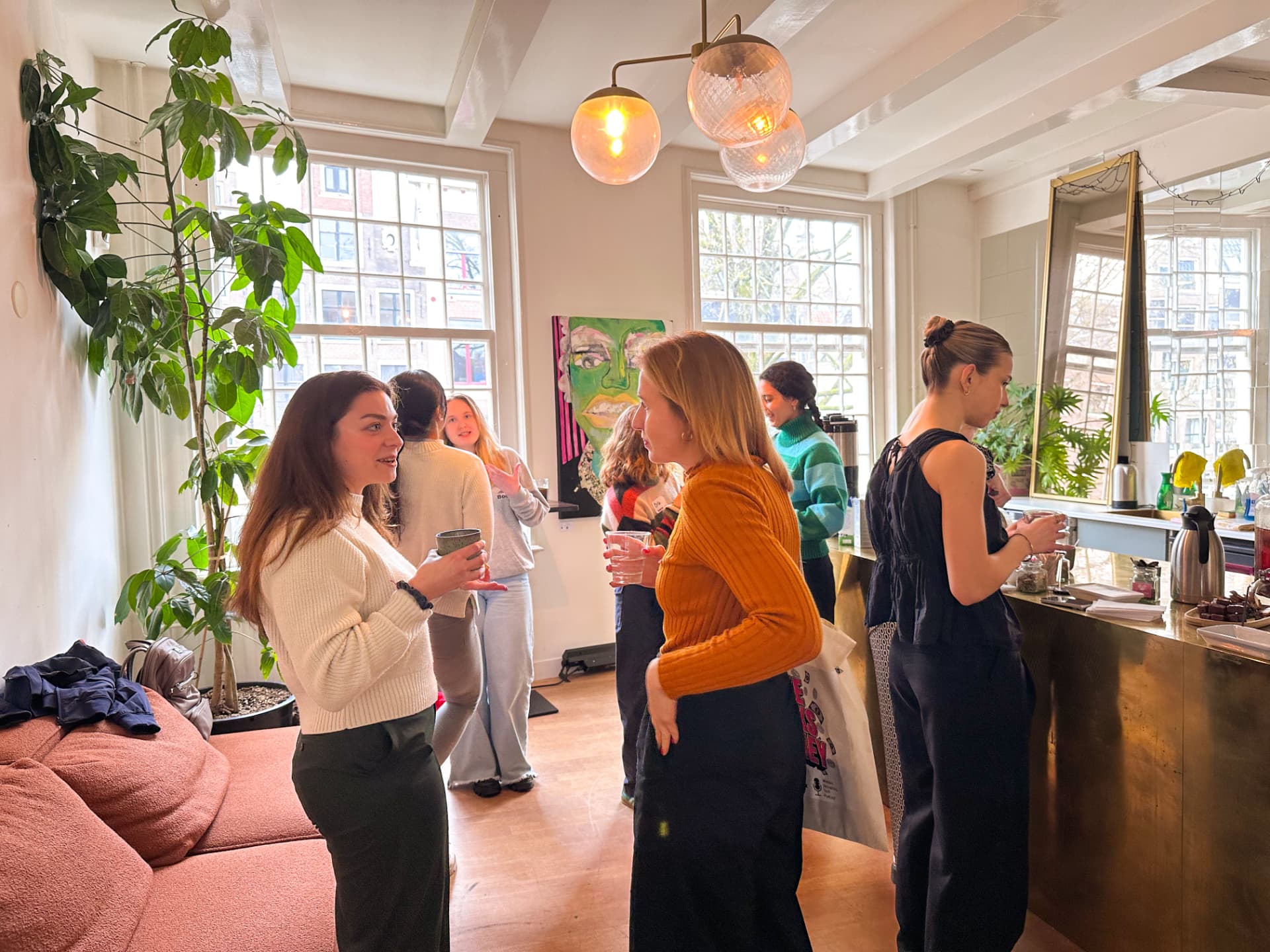 Women connecting over coffee at an impowr event